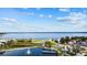Scenic aerial view featuring a tranquil lake, fountain and a manicured park with walking paths on a sunny day at 1024 Green Gate Blvd, Groveland, FL 34736
