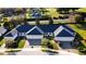 A high angle view of a light colored residential home with a dark roof and well manicured lawn and landscaping at 1024 Green Gate Blvd, Groveland, FL 34736