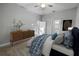 A well-designed bedroom features a nice wood dresser, a beautiful bed, and a ceiling fan at 1024 Green Gate Blvd, Groveland, FL 34736