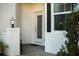 Inviting front entrance featuring a decorative glass door, sleek black sidelight, and a welcoming covered porch at 1024 Green Gate Blvd, Groveland, FL 34736