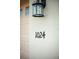 Close-up of the house number '1024' affixed to the exterior wall near the garage door at 1024 Green Gate Blvd, Groveland, FL 34736