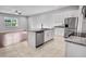Stylish kitchen features granite countertops, stainless steel appliances, an island, and open layout to living area at 1024 Green Gate Blvd, Groveland, FL 34736
