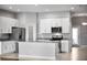 Bright kitchen featuring white cabinetry, stainless steel appliances, granite counters, and a functional center island at 1024 Green Gate Blvd, Groveland, FL 34736