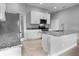 Granite island, stainless appliances, tile floor, and pantry door make this kitchen a chef's dream at 1024 Green Gate Blvd, Groveland, FL 34736
