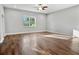 A bright living room area has hardwood floors, a ceiling fan, and lots of space at 1024 Green Gate Blvd, Groveland, FL 34736