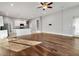 Expansive living room featuring hardwood floors and natural light, seamlessly connected to the adjacent kitchen area at 1024 Green Gate Blvd, Groveland, FL 34736