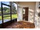 Screened-in patio featuring wood-patterned flooring, a view of the backyard, and an open doorway to the interior at 1024 Green Gate Blvd, Groveland, FL 34736