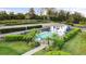 An aerial shot of a community pool featuring a poolside cabana and fenced surround at 1024 Green Gate Blvd, Groveland, FL 34736