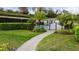 Community pool with a paved walkway, pool-side cabana, and security gate at 1024 Green Gate Blvd, Groveland, FL 34736