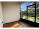 A screened porch features beautiful wood floors and a view of the outdoors at 1024 Green Gate Blvd, Groveland, FL 34736