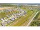 Expansive neighborhood aerial with manicured lawns, modern houses, and winding streets in a planned community at 103 White Horse Way, Groveland, FL 34736