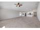 Open-concept living room showcases tile floors, neutral walls, and connects to the kitchen at 103 White Horse Way, Groveland, FL 34736