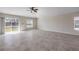 Bright living room featuring tile floors, a ceiling fan, and sliding glass doors with a view of the outdoors at 103 White Horse Way, Groveland, FL 34736