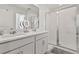 Modern bathroom featuring a double vanity, quartz countertop and glass enclosed shower at 11356 Sunsail Ave, Orlando, FL 32832