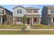 Two-story home with red shutters and a well-manicured lawn showcases charming curb appeal at 11356 Sunsail Ave, Orlando, FL 32832