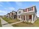 Street view of houses with red shutters and landscaping featuring well-maintained lawns at 11356 Sunsail Ave, Orlando, FL 32832
