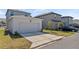 View of a two-car detached garage with driveway and landscaping at 11356 Sunsail Ave, Orlando, FL 32832