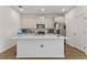 Modern kitchen featuring stainless steel appliances and a large center island with a white countertop at 11356 Sunsail Ave, Orlando, FL 32832