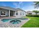 Backyard showcasing a pool, spa, patio, and well-maintained landscaping, perfect for entertaining at 11537 Claymont Cir, Windermere, FL 34786