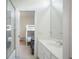 Bright bathroom with glass door shower, modern sink and views to the bedroom with bunk beds at 11537 Claymont Cir, Windermere, FL 34786