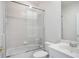 Bright bathroom featuring a shower-over-tub, white tiles, and a modern sink at 11537 Claymont Cir, Windermere, FL 34786