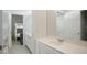 Bright bathroom with sink, modern mirror and views to the bedroom with bunk beds at 11537 Claymont Cir, Windermere, FL 34786