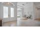 Bright entryway with double doors, light tile floors, and a sitting area with natural light from the large arched window at 11537 Claymont Cir, Windermere, FL 34786