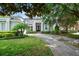 Charming home featuring a well-manicured lawn, mature trees, and an inviting entrance at 11537 Claymont Cir, Windermere, FL 34786