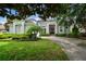 Lovely home featuring lush landscaping, mature trees, and an inviting front entrance at 11537 Claymont Cir, Windermere, FL 34786
