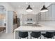 Bright and airy kitchen with gray cabinets, quartz countertops, stainless appliances, and breakfast bar seating at 11537 Claymont Cir, Windermere, FL 34786