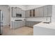 Well-lit kitchen with quartz countertops, stainless steel appliances, and grey cabinets at 11537 Claymont Cir, Windermere, FL 34786