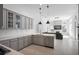 Modern kitchen featuring stainless steel appliances, gray cabinets, quartz countertops, and pendant lighting at 11537 Claymont Cir, Windermere, FL 34786