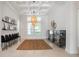 Bright living room with coffered ceiling, featuring neutral decor, black chairs and abundant natural light at 11537 Claymont Cir, Windermere, FL 34786
