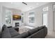 Cozy living room featuring a modern fireplace, wall-mounted TV, and lots of natural light at 11537 Claymont Cir, Windermere, FL 34786