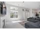 Sunlit living room with fireplace, large windows and views to the kitchen at 11537 Claymont Cir, Windermere, FL 34786