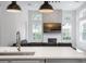 Open-concept living room featuring a fireplace, large windows, and modern lighting fixtures at 11537 Claymont Cir, Windermere, FL 34786