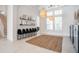 Bright, open living room with neutral decor, large area rug and adjacent staircase at 11537 Claymont Cir, Windermere, FL 34786