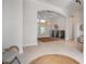 Spacious living room with archway and coffered ceiling, featuring neutral decor and abundant natural light at 11537 Claymont Cir, Windermere, FL 34786