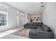 Bright living room featuring an open floor plan with modern gray sofa and kitchen view at 11537 Claymont Cir, Windermere, FL 34786