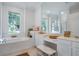 Bright main bathroom with double vanity, soaking tub, and separate glass-enclosed shower at 11537 Claymont Cir, Windermere, FL 34786