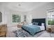 Spacious main bedroom with tray ceiling, large windows, and a comfortable sitting area with natural light at 11537 Claymont Cir, Windermere, FL 34786