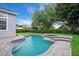 Backyard oasis with a sparkling pool, integrated spa, and lush landscaping, ideal for relaxation at 11537 Claymont Cir, Windermere, FL 34786