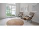 Bright sitting area with natural light, with a textured rug, wicker chairs, and neutral walls at 11537 Claymont Cir, Windermere, FL 34786
