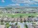Scenic aerial view showcases neighborhood homes, golf course and nearby lakes at 13067 Woodford St, Orlando, FL 32832