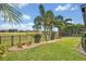 Well-manicured lawn with flowering plants and a view of the golf course at 13067 Woodford St, Orlando, FL 32832