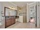 Bright bathroom with a glass shower, granite countertop vanity, and access to the main bedroom at 13067 Woodford St, Orlando, FL 32832