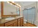 Bathroom boasts double sinks, granite countertop and wood cabinets, with natural light and spacious layout at 13067 Woodford St, Orlando, FL 32832