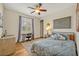 This bedroom features an organized desk, a bed with soft pillows, and a ceiling fan for a cozy feel at 13067 Woodford St, Orlando, FL 32832