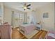 Cozy bedroom with wood floors and decor with natural light from the large window at 13067 Woodford St, Orlando, FL 32832