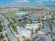 Aerial view of community amenities including pools, tennis courts, and playground at 13067 Woodford St, Orlando, FL 32832